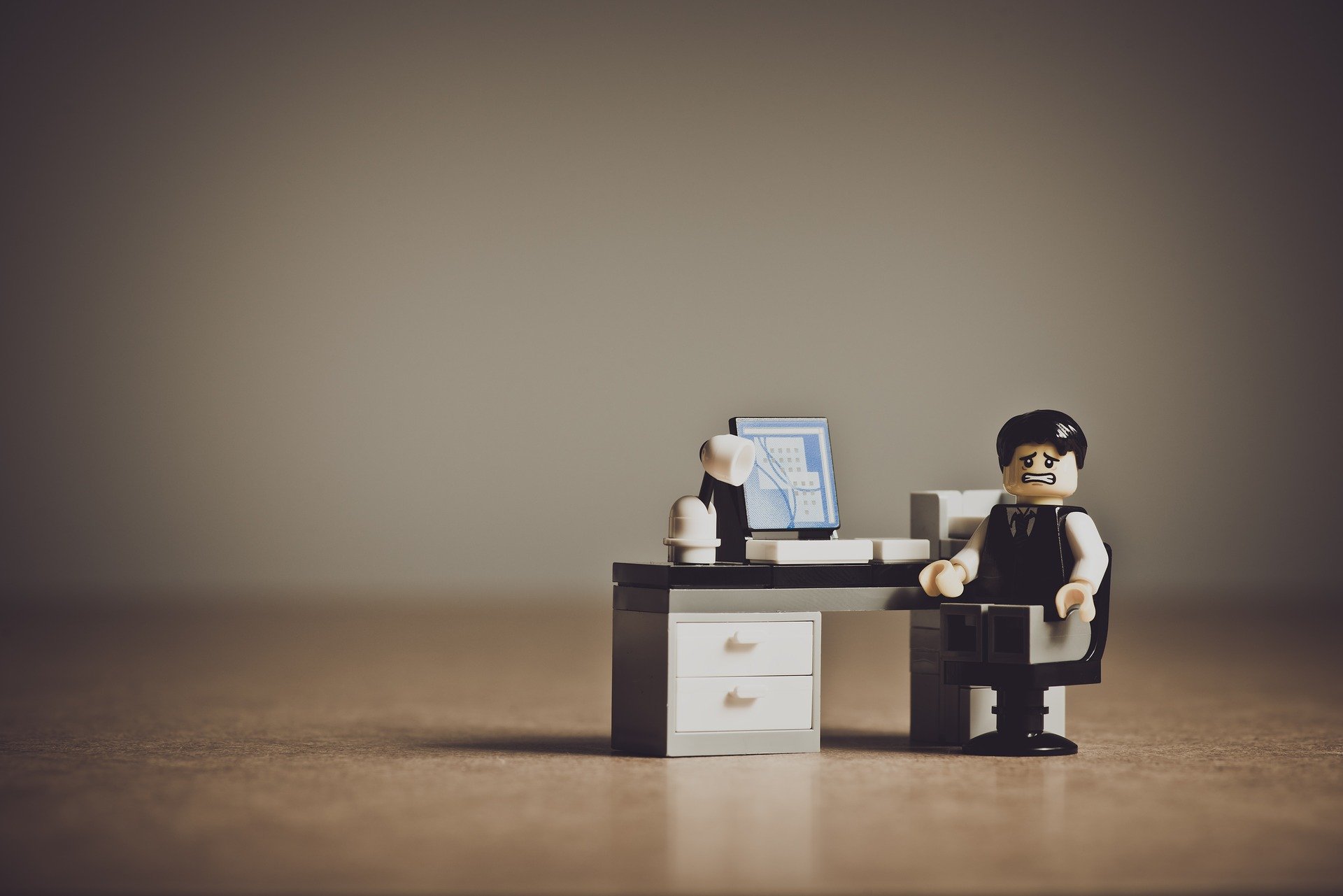 A toy figure seen working at a desk